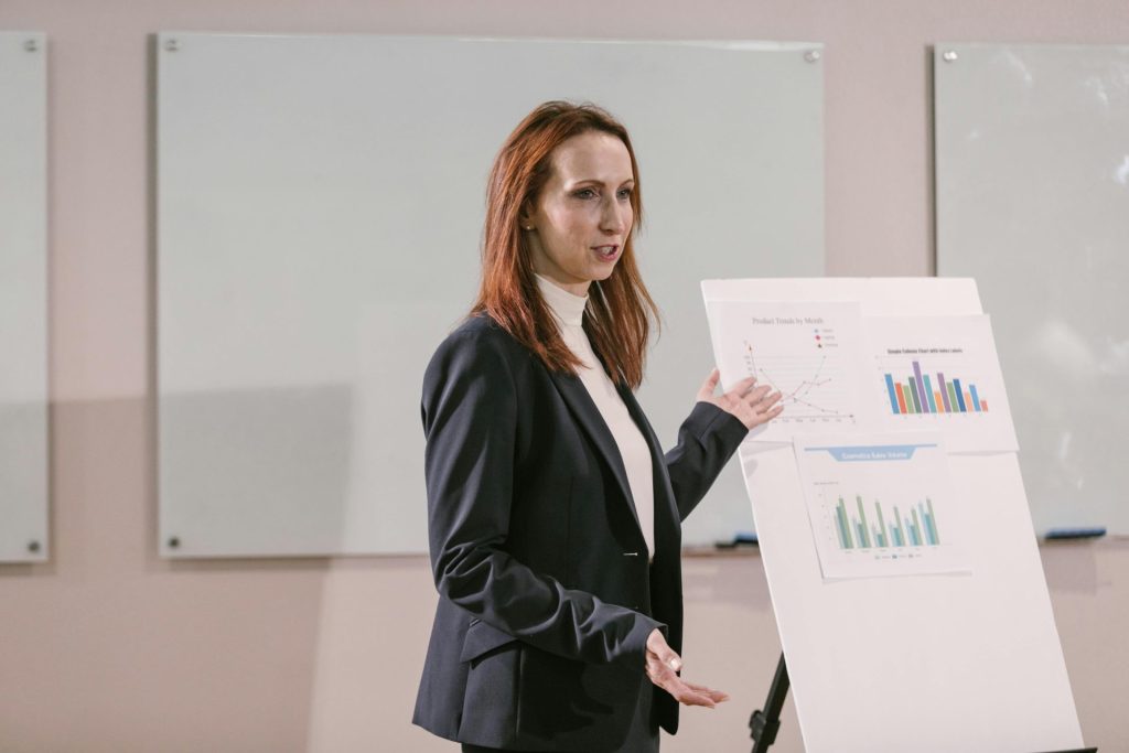 Confident businesswoman delivers presentation with charts at a professional conference.